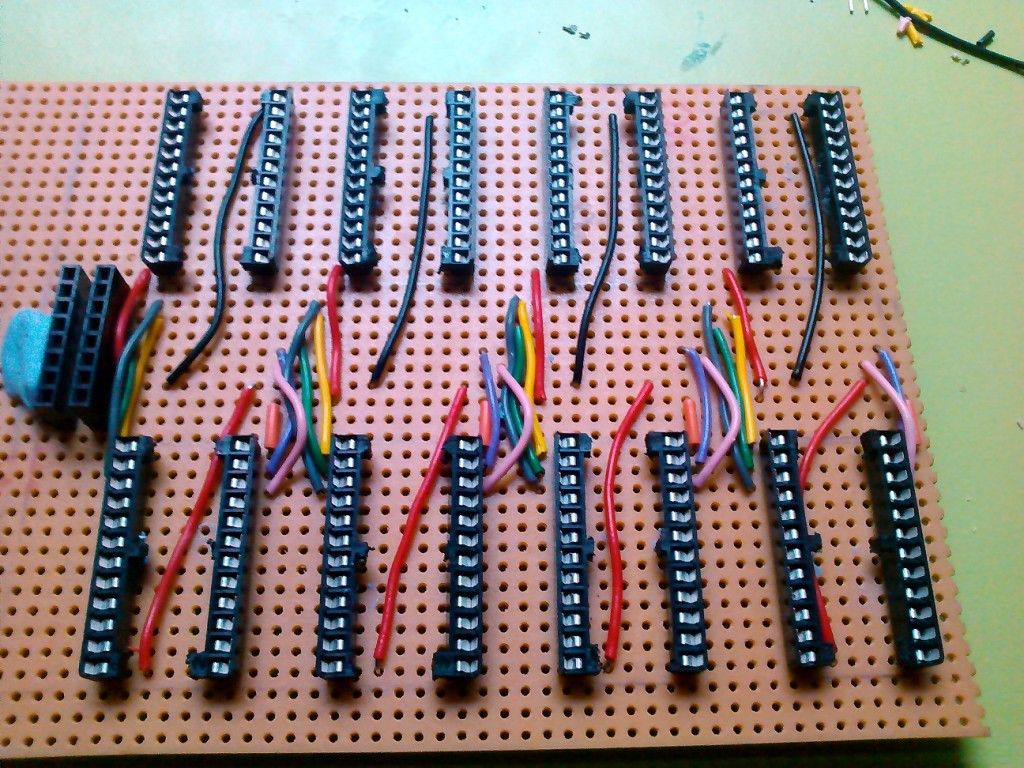Building the board, (with narrow 24 pin IC holders sliced down the middle). The input comes in via a common bus down the centre of the board.